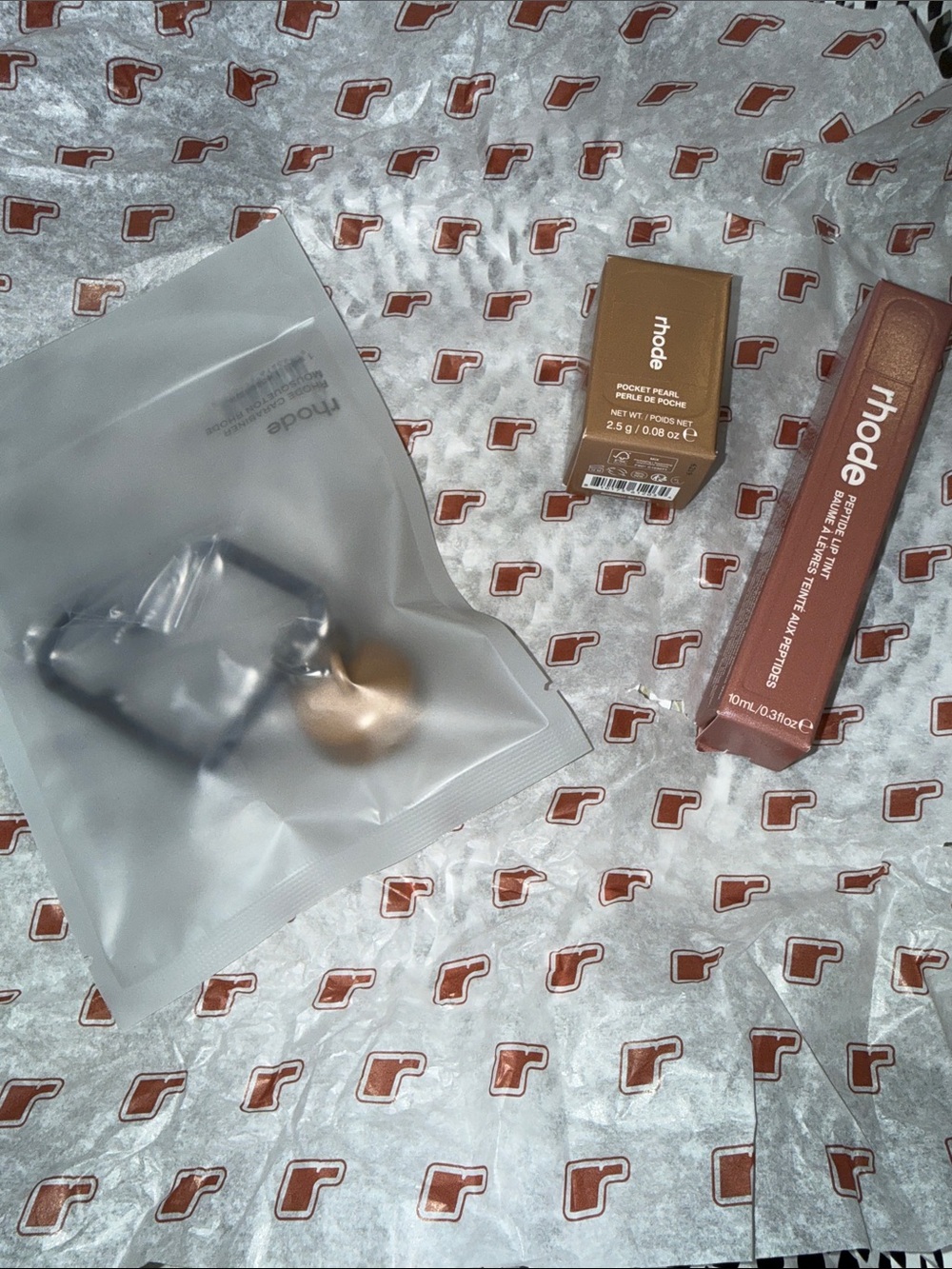 Rhode skin carabiner, pocket blush in Montaco, and peptide lip tint sweet Apple
